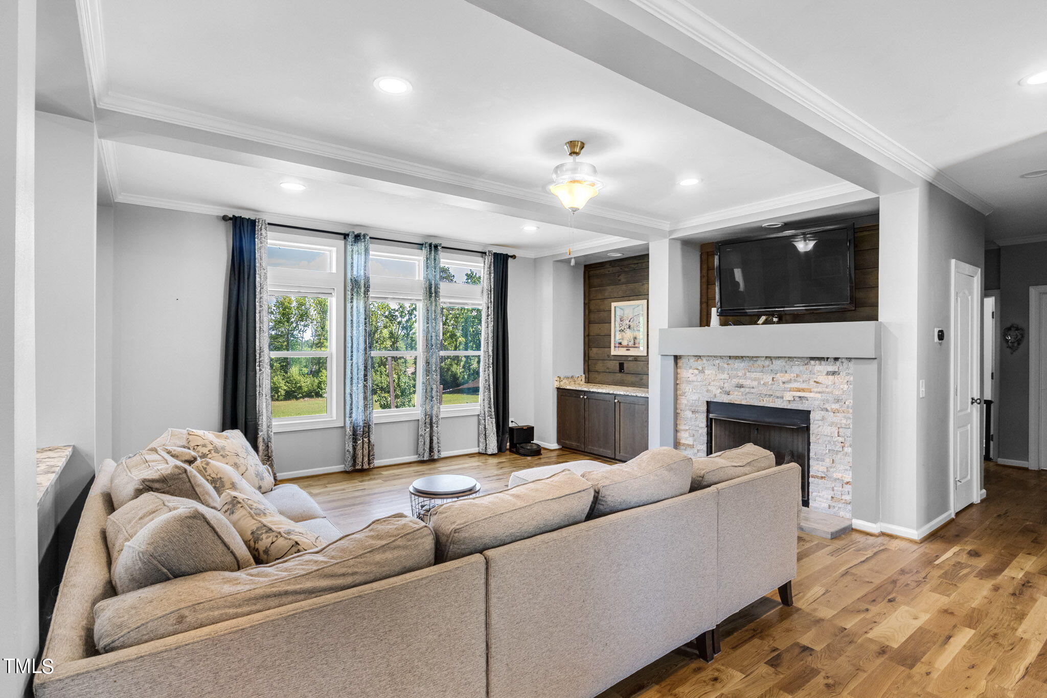 3218 Old N C 75 Stem, NC 27581 - Photo 29 of 35 a living room with furniture a fireplace and a flat screen tv