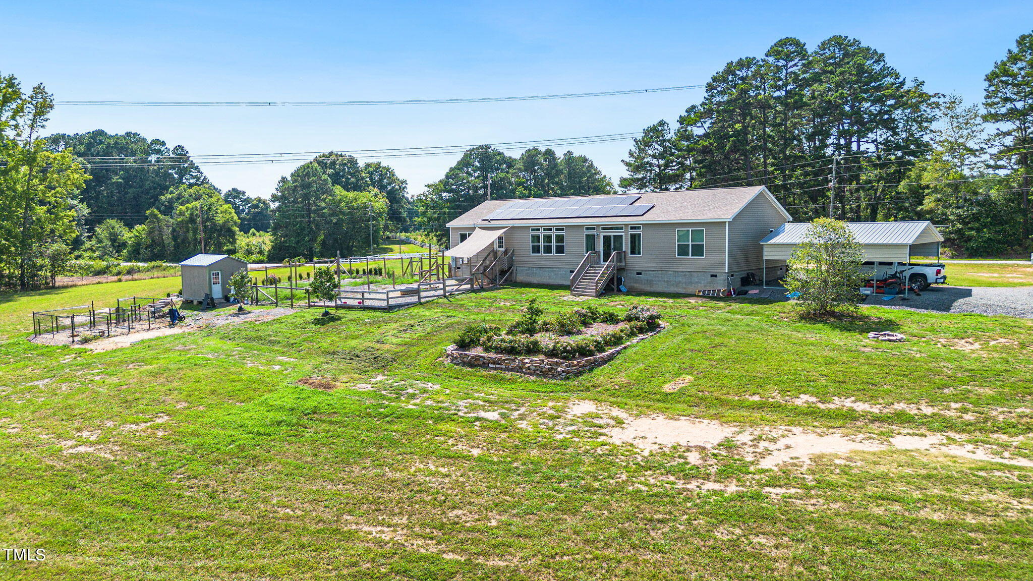 3218 Old N C 75 Stem, NC 27581 - Photo 8 of 35 a view of a house with a big yard potted plants and large tree