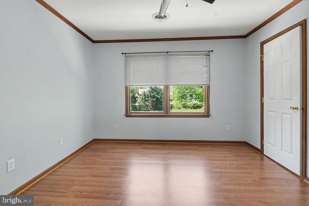 1204 A Old Coochs Bridge Road Newark, DE 19713 - Photo 22 of 31 a view of an empty room with wooden floor and a window