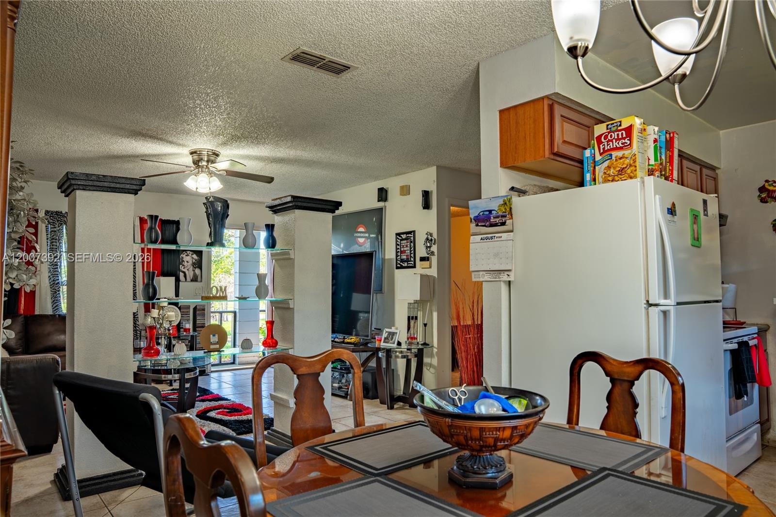 6924 Holly Creek Road Mount Dora, FL 32757 - Photo 15 of 25 a view of a dining room with furniture and a chandelier