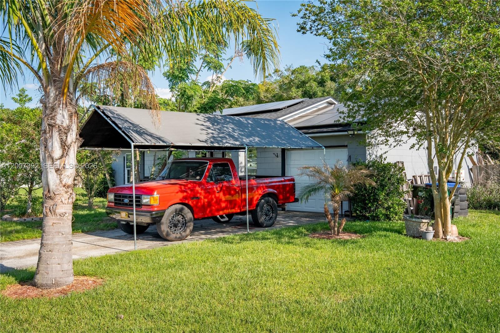 6924 Holly Creek Road Mount Dora, FL 32757 - Photo 22 of 25 a front view of a house with garden
