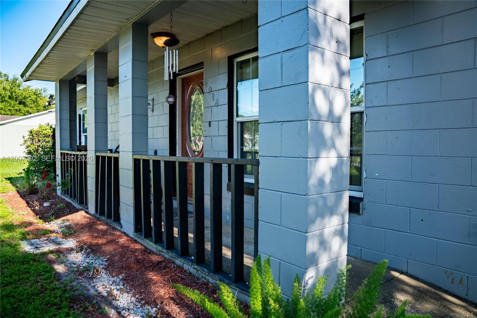 6924 Holly Creek Road Mount Dora, FL 32757 - Photo 25 of 25 a view of a brick house with a small yard