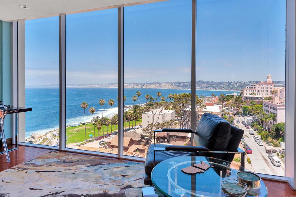 939 Coast Boulevard La Jolla, CA 92037 - Photo 1 of 36 a living room with furniture and a floor to ceiling window