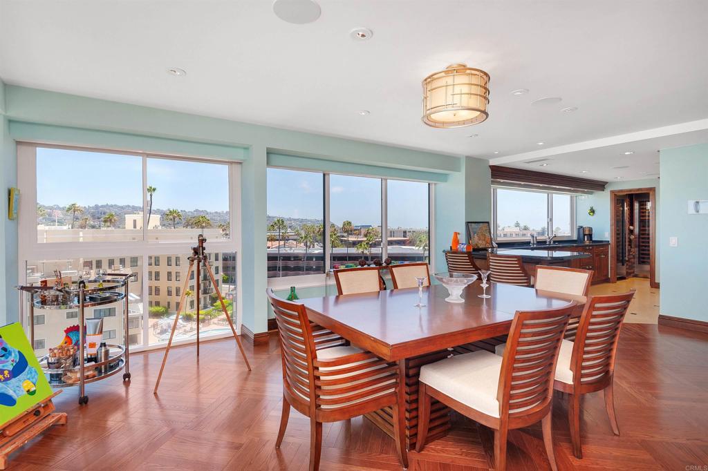 939 Coast Boulevard La Jolla, CA 92037 - Photo 15 of 36 a dining room with furniture a rug and a floor to ceiling window