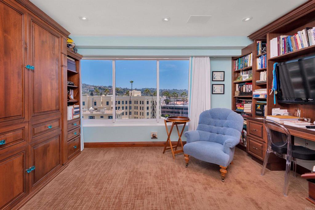 939 Coast Boulevard La Jolla, CA 92037 - Photo 23 of 36 a living room with furniture and a flat screen tv