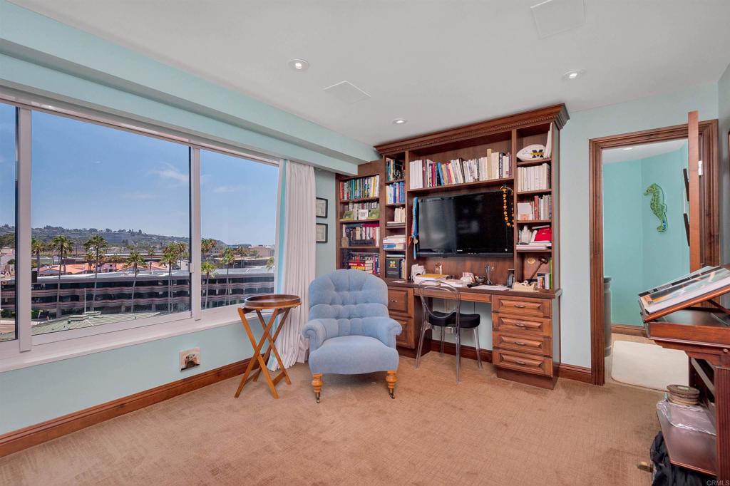939 Coast Boulevard La Jolla, CA 92037 - Photo 24 of 36 a living room with furniture and a flat screen tv