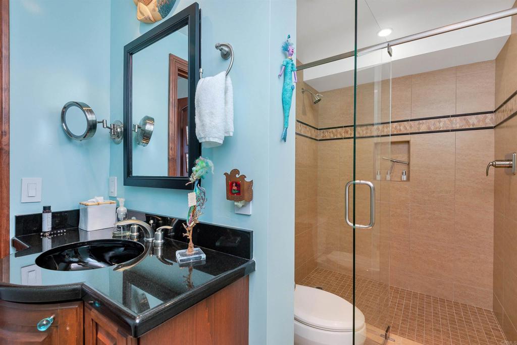 939 Coast Boulevard La Jolla, CA 92037 - Photo 25 of 36 a bathroom with a sink a toilet and shower