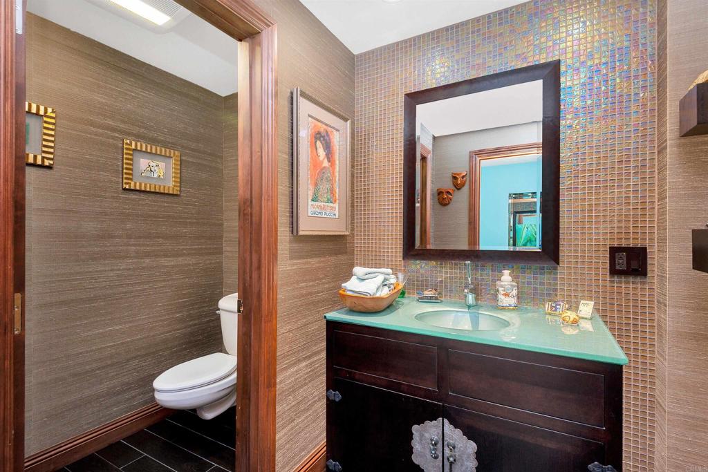 939 Coast Boulevard La Jolla, CA 92037 - Photo 26 of 36 a bathroom with a granite countertop toilet sink and mirror