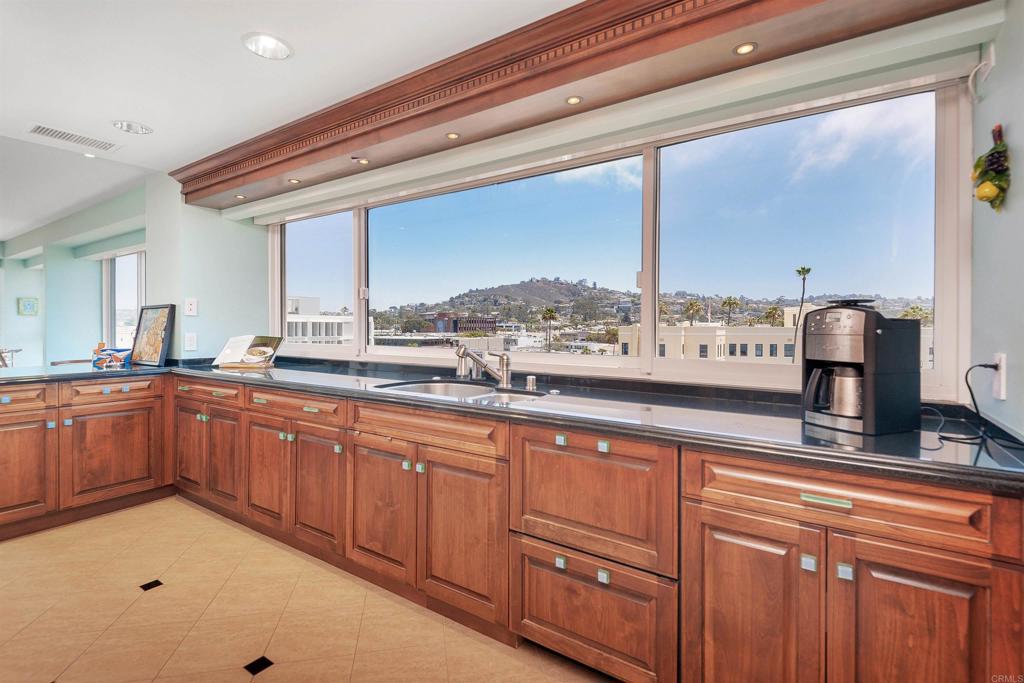 939 Coast Boulevard La Jolla, CA 92037 - Photo 6 of 36 a large kitchen with cabinets