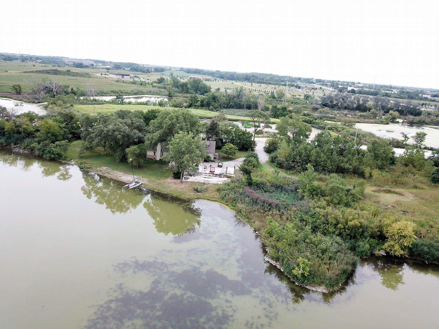 an aerial view of lake residential house with outdoor space and trees