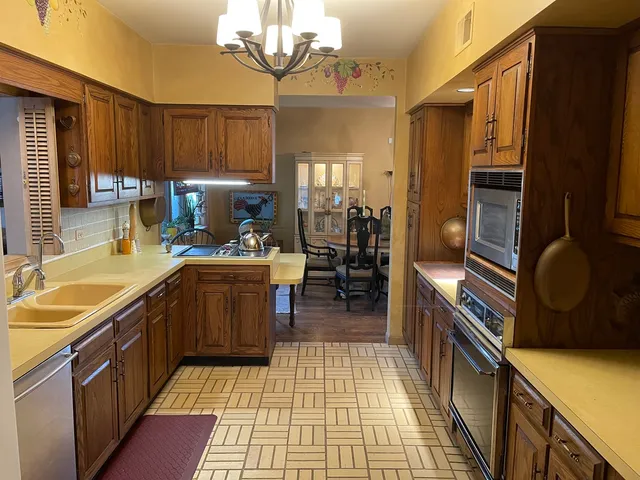 a kitchen with a sink appliances and cabinets