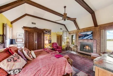 a bed room with a bed furniture and a fireplace