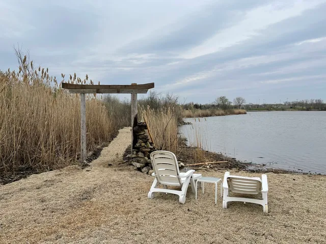 a lawn chairs sitting in the middle of a yard