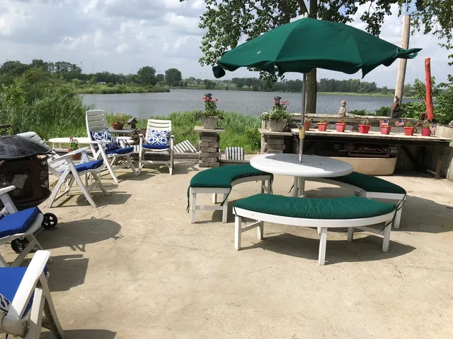 a view of a swimming pool with chair and table in the patio