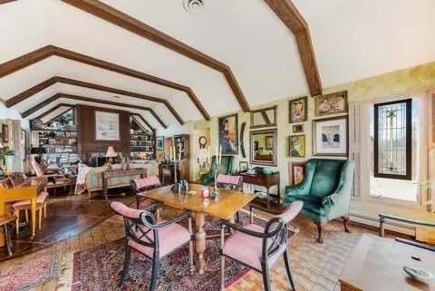 a living room with fireplace furniture and a potted plant