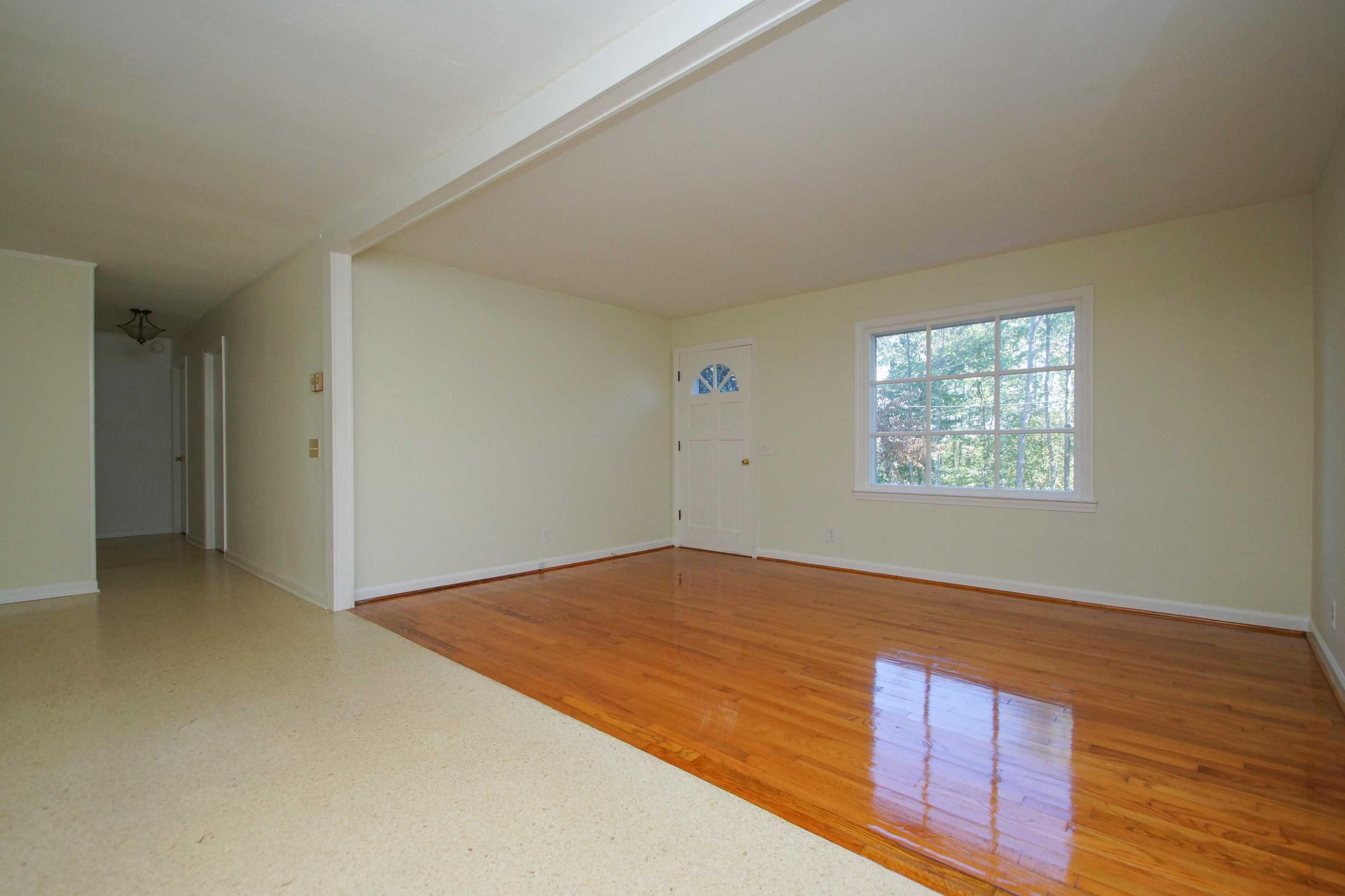 361 Power Dam Road Rocky Mount, VA 24151 - Photo 12 of 25 an empty room with wooden floor and windows