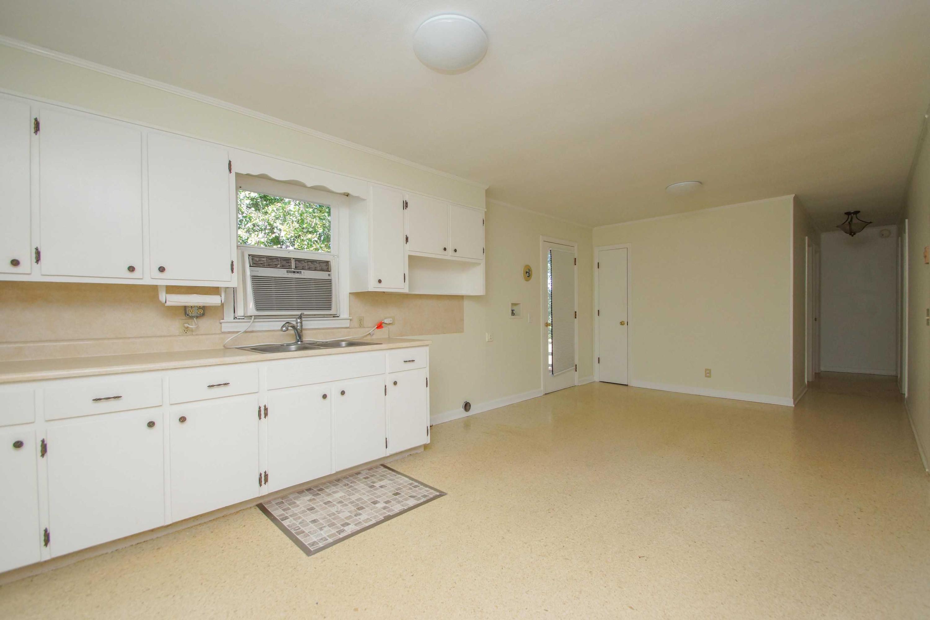 361 Power Dam Road Rocky Mount, VA 24151 - Photo 17 of 25 a kitchen with cabinets appliances a sink and a window