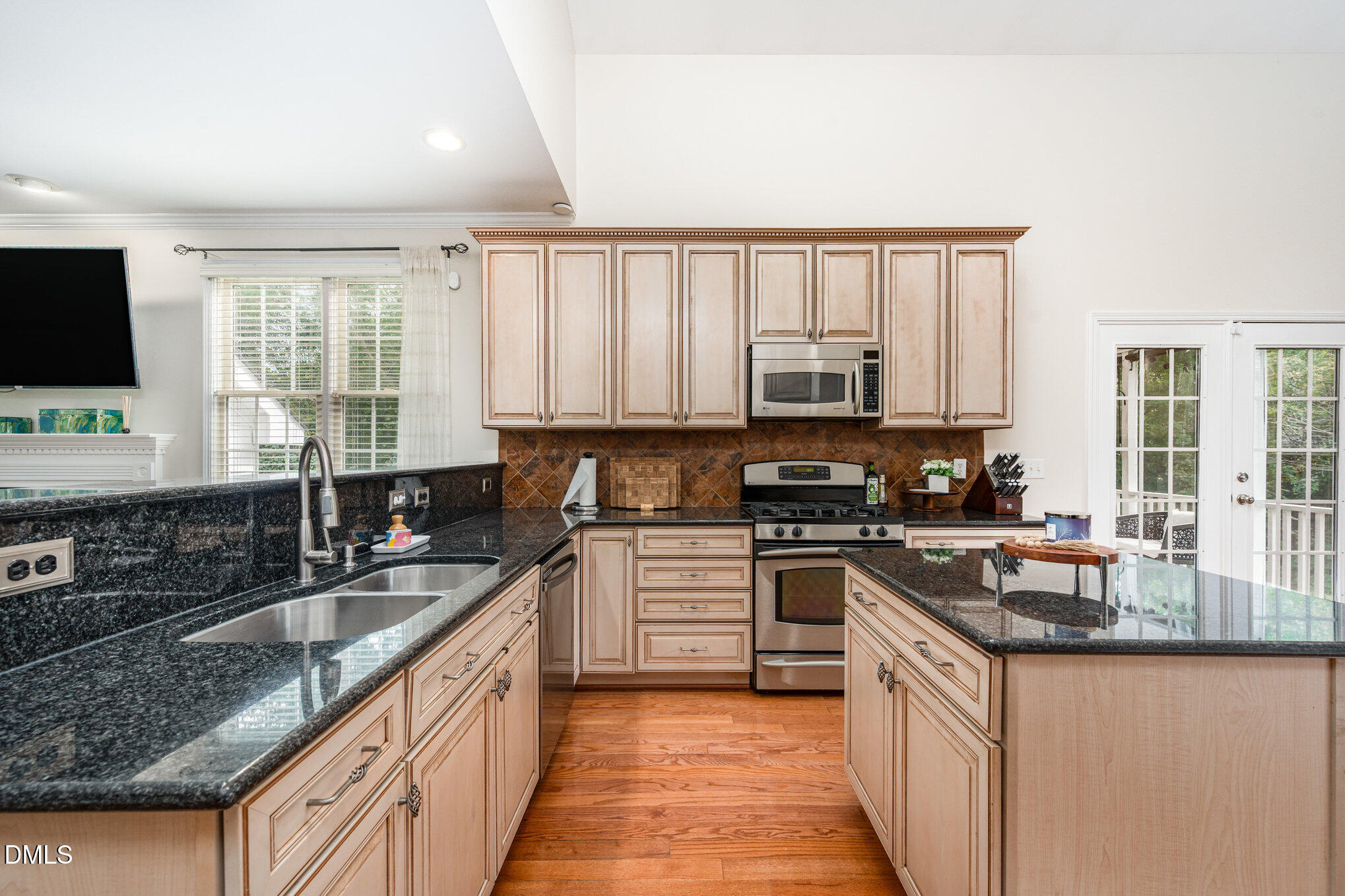 2116 Covered Bridge Court Raleigh, NC 27614 - Photo 13 of 36 a kitchen with granite countertop a stove sink microwave and refrigerator