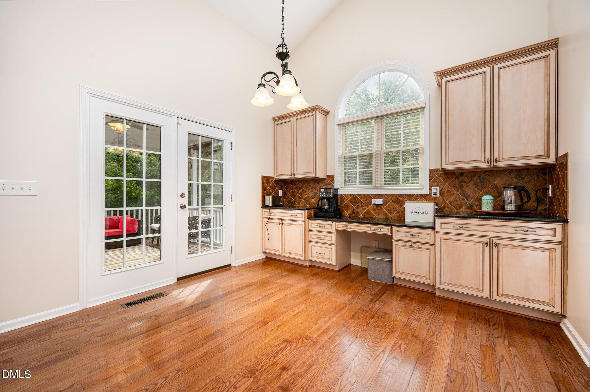 2116 Covered Bridge Court Raleigh, NC 27614 - Photo 16 of 36 a kitchen with granite countertop a stove a sink and white cabinets with wooden floor