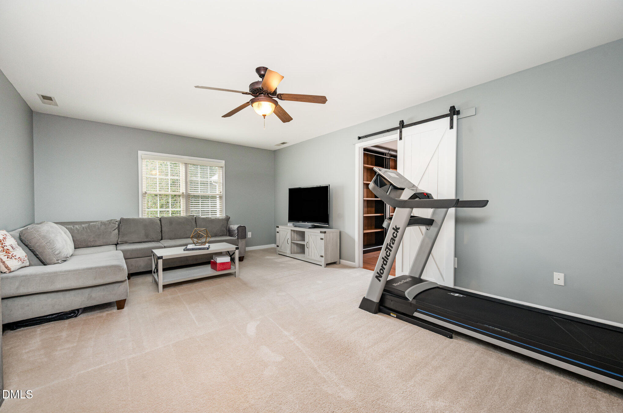 2116 Covered Bridge Court Raleigh, NC 27614 - Photo 32 of 36 a living room with furniture gym equipment and a window