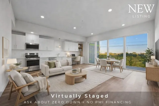 a living room with lots of furniture and view of kitchen