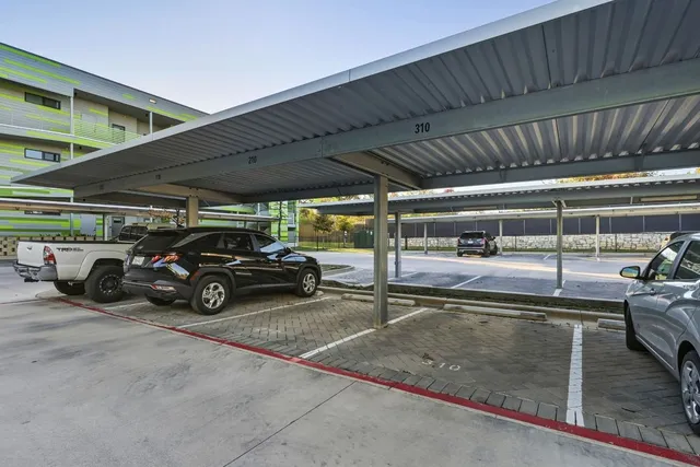 a view of parking garage with cars parked