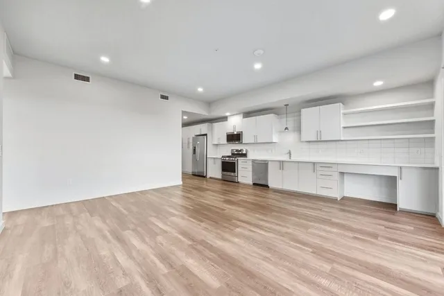 a view of a kitchen with kitchen and stainless steel appliances