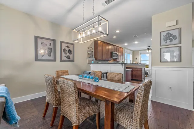 a spacious bedroom with a bed a couch and a chandelier