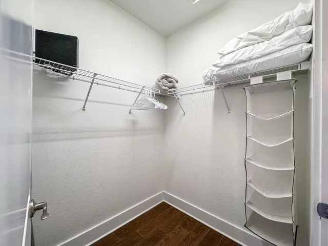 a bathroom with a granite countertop toilet a sink and a mirror