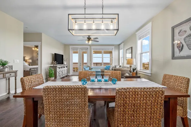 a view of a dining room with furniture a chandelier and wooden floor