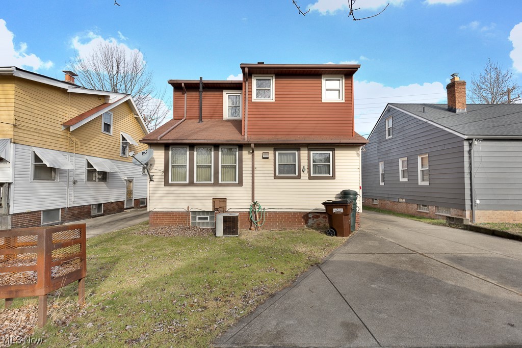8007 Snow Road Parma, OH 44129 - Photo 25 of 25 Back of property with a lawn and central AC