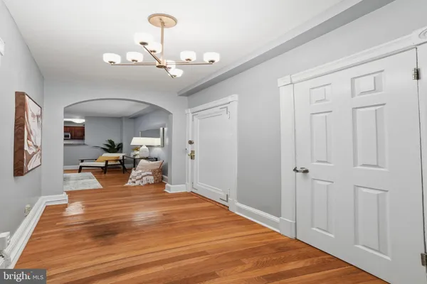 a view of a livingroom with furniture a chandelier
