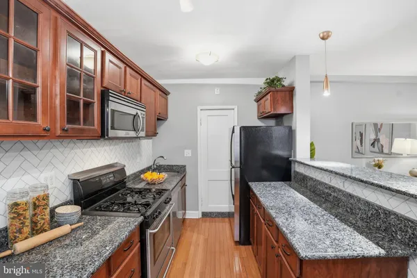 a kitchen with stainless steel appliances granite countertop a stove and a sink