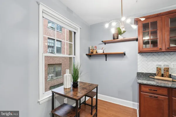 a dining room with wooden floor and breakfast area