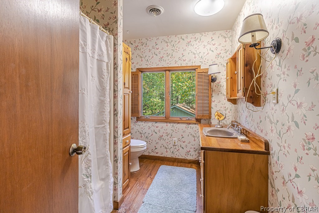131 Ewell Road Lancaster, VA 22503 - Photo 37 of 50 a bathroom with a granite countertop sink a mirror and shower
