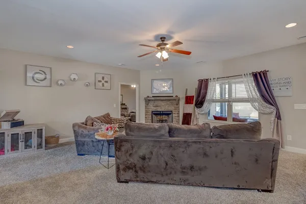 a living room with fireplace furniture and a window