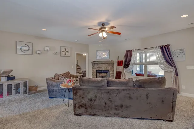 a living room with fireplace furniture and a window