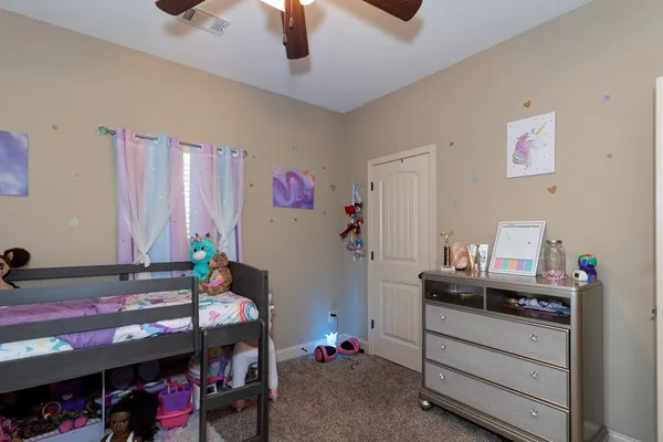 a bedroom with a bed and a desk
