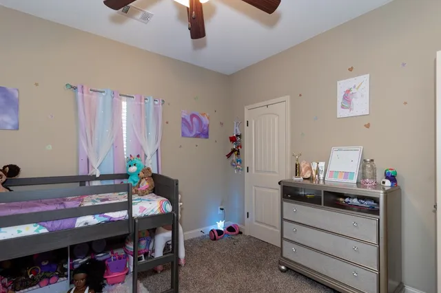 a bedroom with a bed and a desk