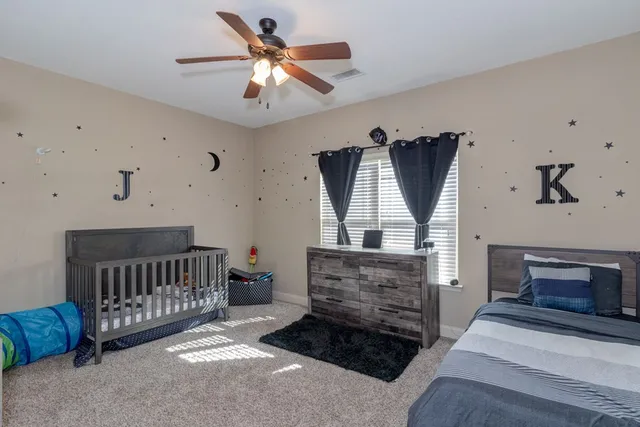 a living room with furniture a fireplace and a window