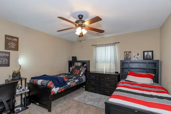 a bedroom with bed and a chandelier