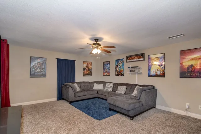 a living room with furniture and a chandelier