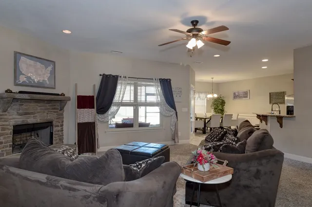 a living room with furniture fireplace and window