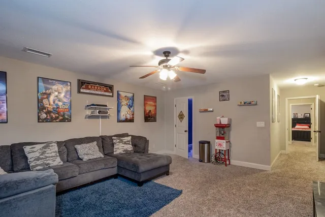 a living room with furniture and a chandelier