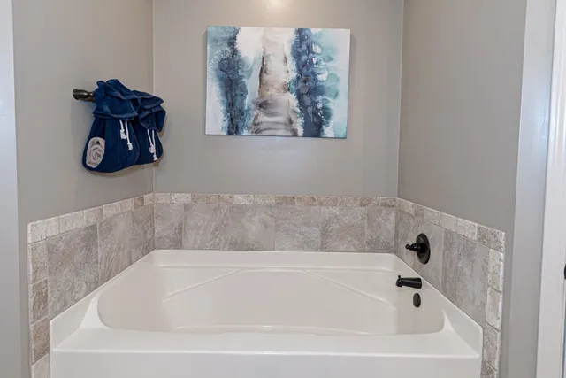 a white bath tub and a window