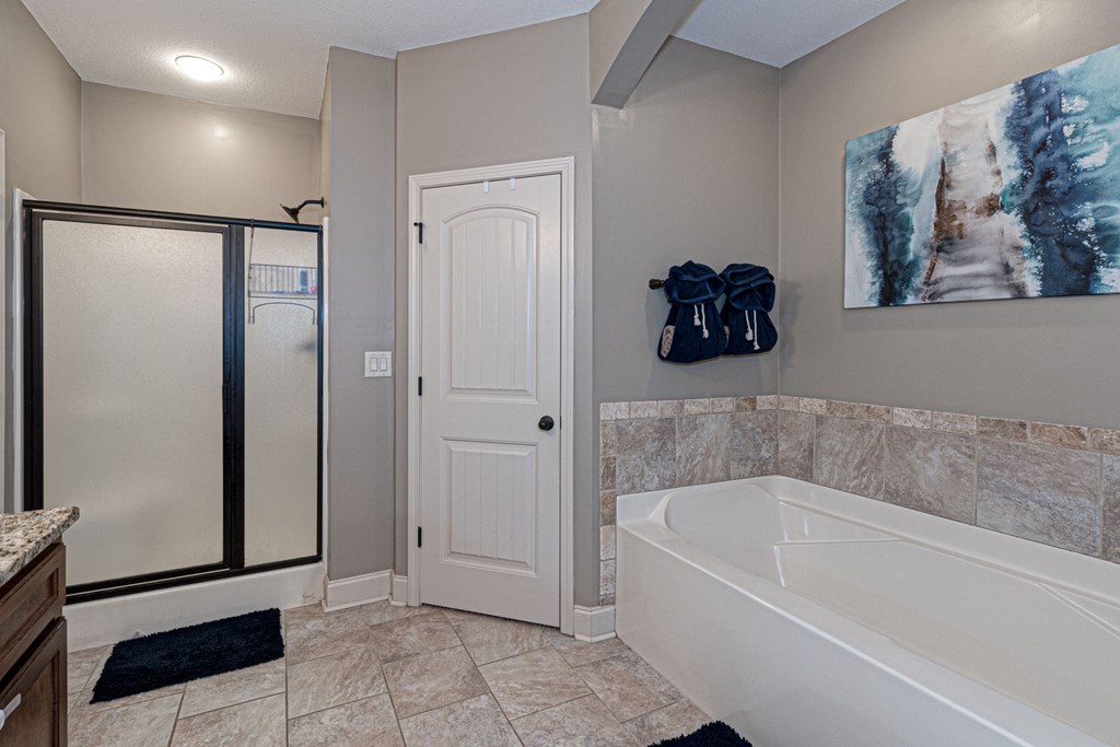 53 Winter Hawk Drive Fort Mitchell, AL 36856 - Photo 30 of 39 a bathroom with a tub shower and hallway