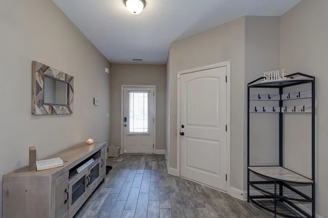 a view of wooden floor and windows in a room