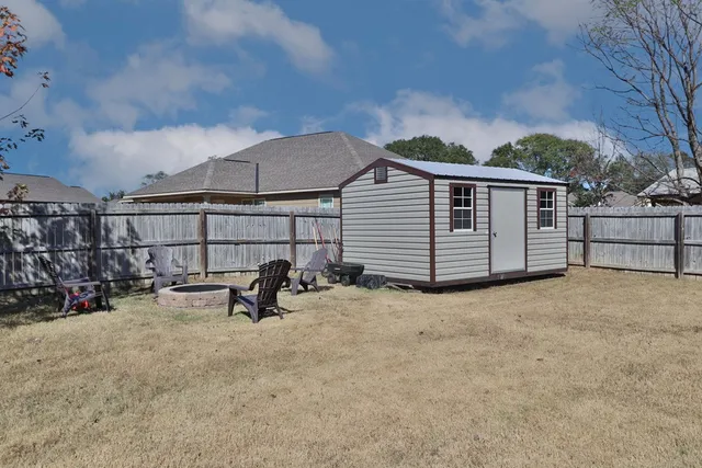 a backyard of a house with table and chairs
