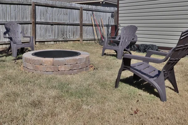 a view of a house with a yard and wooden fence