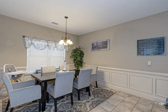 a view of a dining room with furniture and chandelier